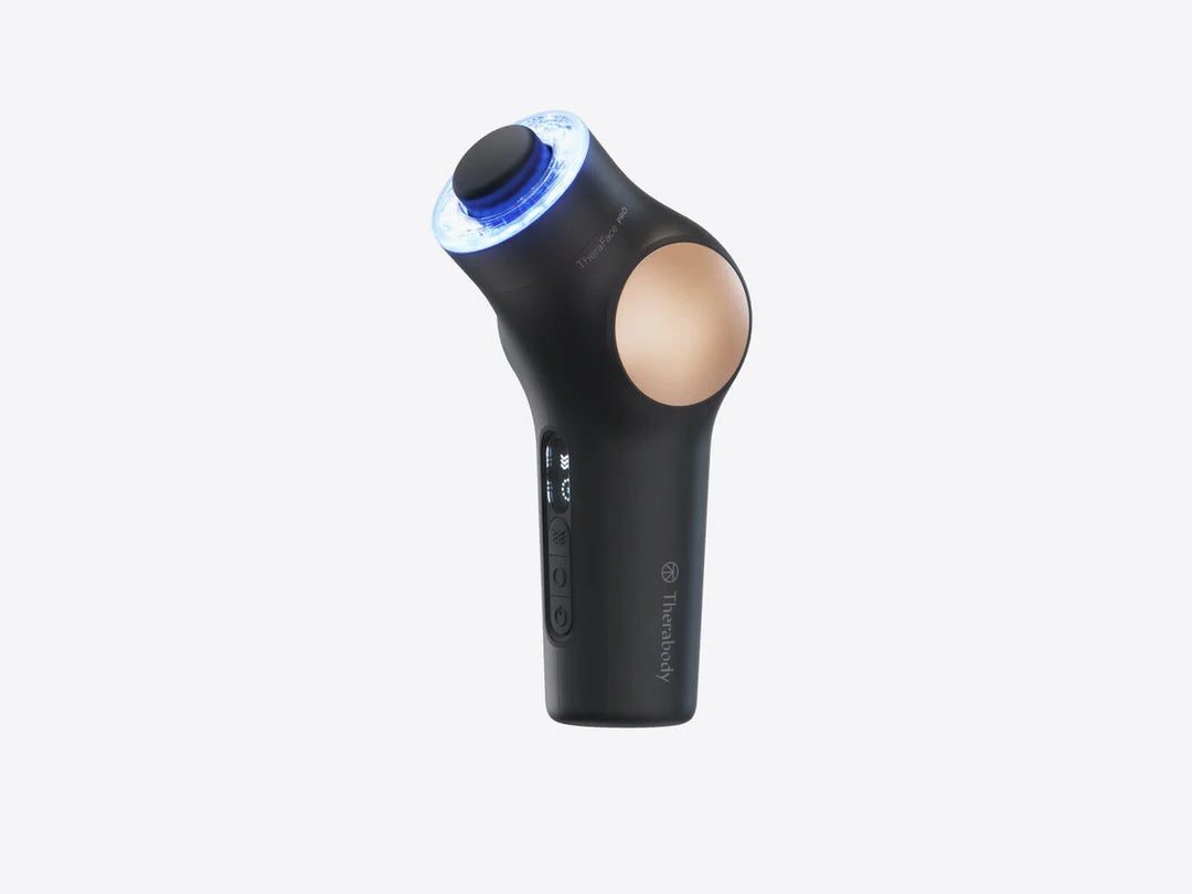 Black TheraFace PRO facial massage gun with blue light therapy against a white background.