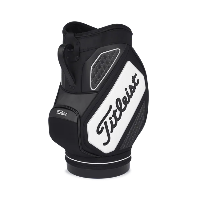 Titleist Den Caddy on a circular foot, designed in black, grey and white accents with the word Titleist angled across and a carrying handle.